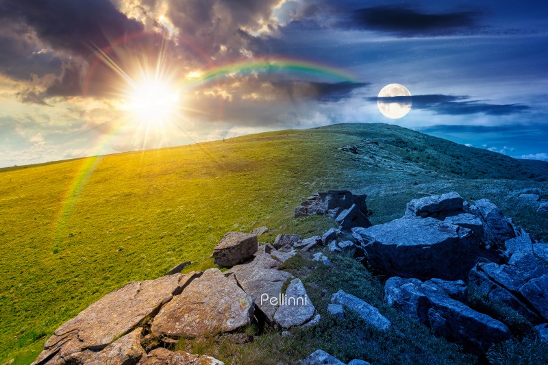 rocks and rolling hills in mountain landscape on summer solstice. day meet night. sun and moon over scenery with green grass on alpine meadow. astrology recreation tourism and wanderlust