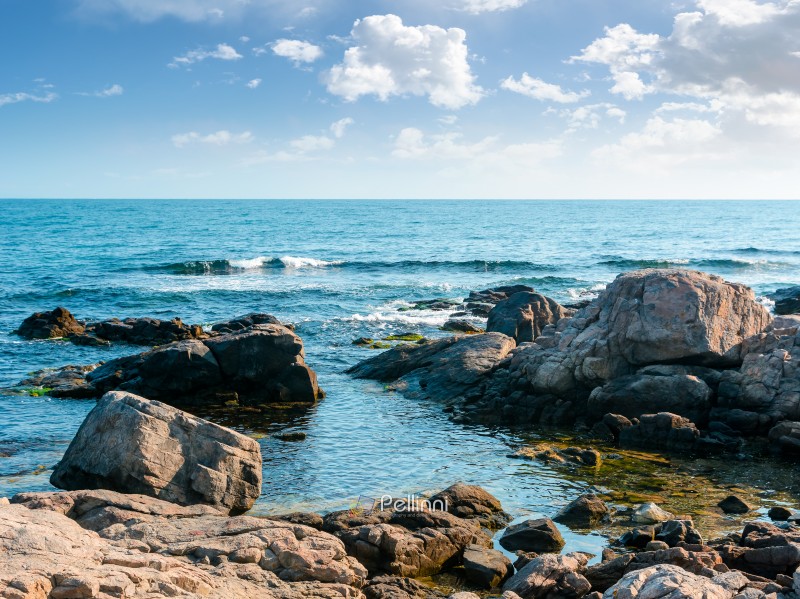 rocky shore of the sea coast under blue sky. beautiful view of c rocky shore of the sea coast under blue sky. beautiful view of coastal bulgaria on a sunny day. resort scenery near sozopol during vacation season in summer. place for vacation, retreats and escape