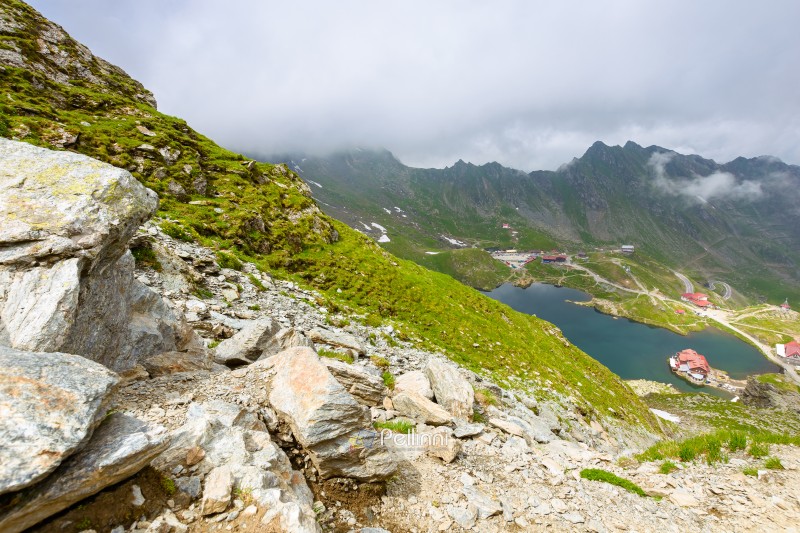 romania travel landscape with road pass. green valley of fagaras mountains. dramatic scenery of transylvania. beautiful view above alpine lake balea in summer. scenic landmark of europe