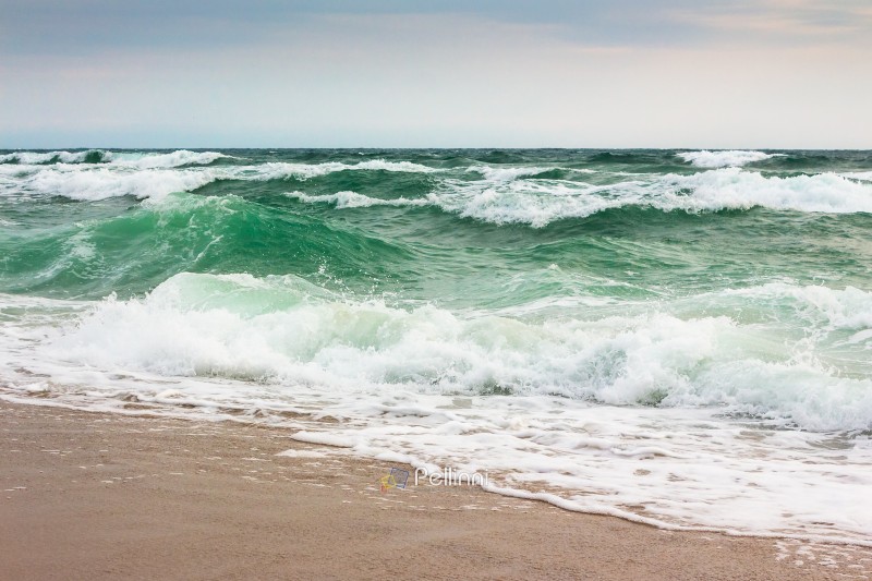 seascape in morning light. bad vacation season background. adventure disaster. stormy weather with cloudy sky in summer. sea wave crashing on the shore. sad wallpaper