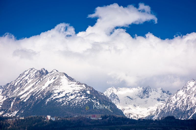 snow capped mountain peaks of high tatras in spring. scenic view snow capped mountain peaks of high tatras in spring. scenic view of popular travel destination for remote trekking in slovakia, europe. alpine landscape with blue sky and clouds above the ridge