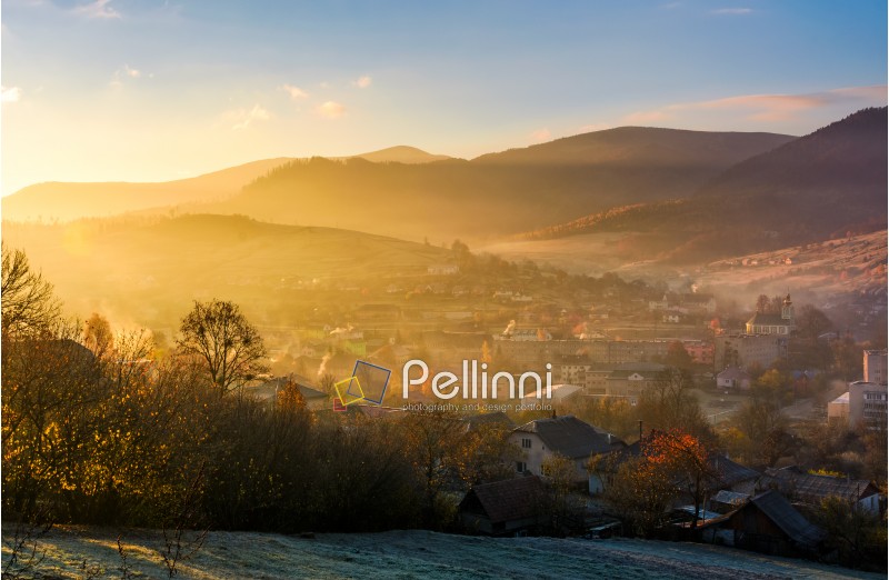 spectacular foggy sunrise in mountainous countryside. gorgeous autumnal landscape with village in mountains in fine weather