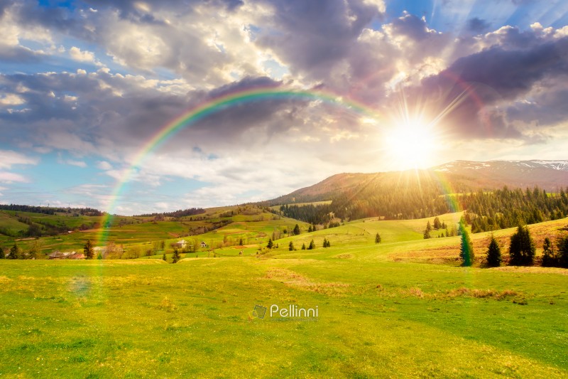 sunset over panoramic view of countryside of Ukraine. wonderful sunset over panoramic view of countryside of Ukraine. wonderful springtime landscape in Carpathian mountains. grassy field and rolling hills. beautiful rural scenery under the rainbow