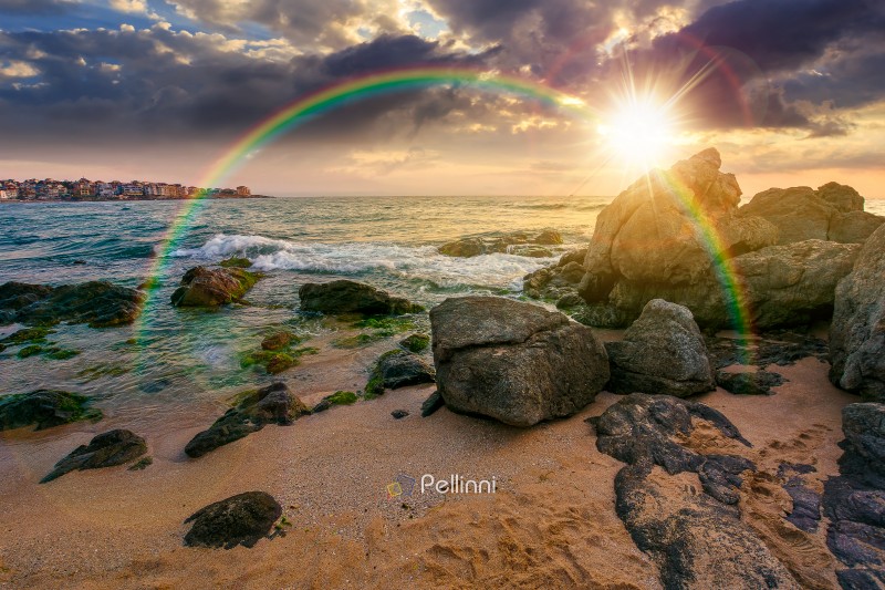 sunset over sandy beach landscape. beautiful coastal seascape scenery under the rainbow. nature background for summer vacation at the shore of black sea with rocks