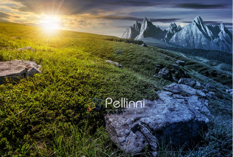 Day and night time change concept in High Tatra mountain summer landscape. Sun and moon over meadow with huge stones among the grass on top of the hillside near the peak of mountain range