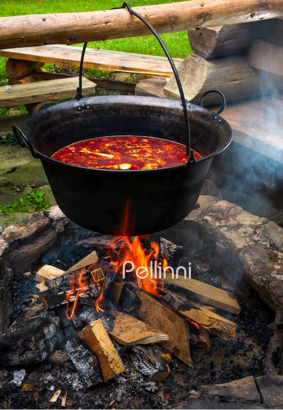 traditional Hungarian Goulash soup in cauldron. meal cooked outdoors on an open fire. delicious and healthy food popular in Central Europe