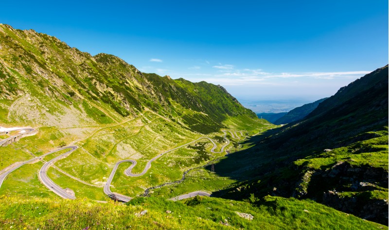 transfagarasan road in mountains of Romania. gorgeous view of the landscape from the edge of a hill. serpentine road with lots of turnarounds is winding down the valley