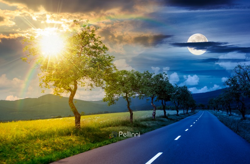 trees along the country road in to mountains. day and night time change concept. beautiful summer landscape with with sun and moon on epic sky. motion blur effect. harmony and progress calendar