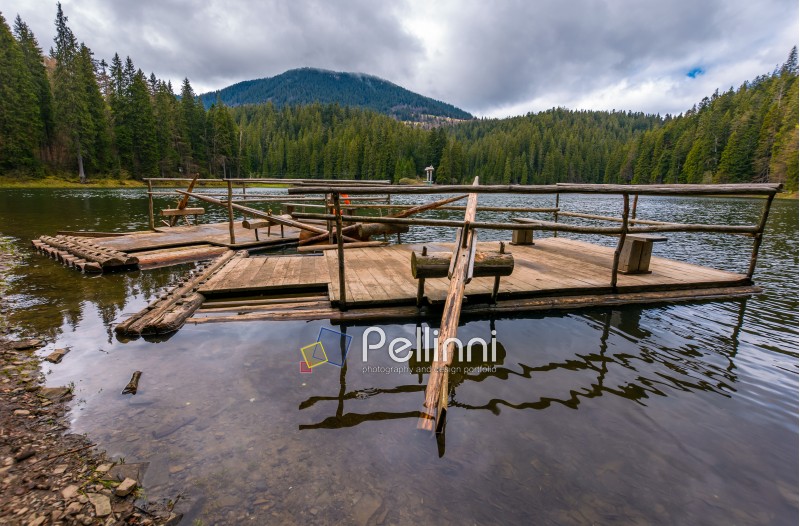 two wooden raft on the shore of Synevyr lake. Beautiful springtime nature scenery in the most visited location of Carpathian mountains