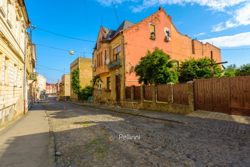 uzhhorod, ukraine - 11 jun 2017: european urban landscape with street of town in morning light. cobblestone path down the hill to koriatovycha square in city center