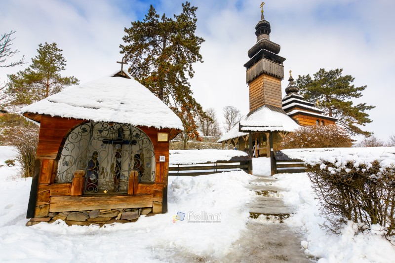 uzhhorod, ukraine - 15 jan 2017: old wooden church of archangel michael in open air museum of folk and architecture in winter. traditional wooden architecture of transcarpathia. heritage of ukraine