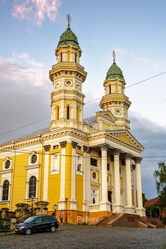 uzhhorod, ukraine - 9 jul 2012: exterior of holy cross greek catholic cathedral on the hill in evening light. beautiful baroque style architecture. prominent religious landmark of europe