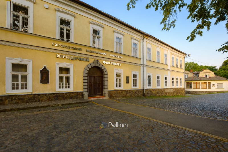 uzhhorod, ukraine - jun 11, 2017: building of the uzhhorod national university, faculty of law on a sunny summer morning. historic architecture situated in the downtown