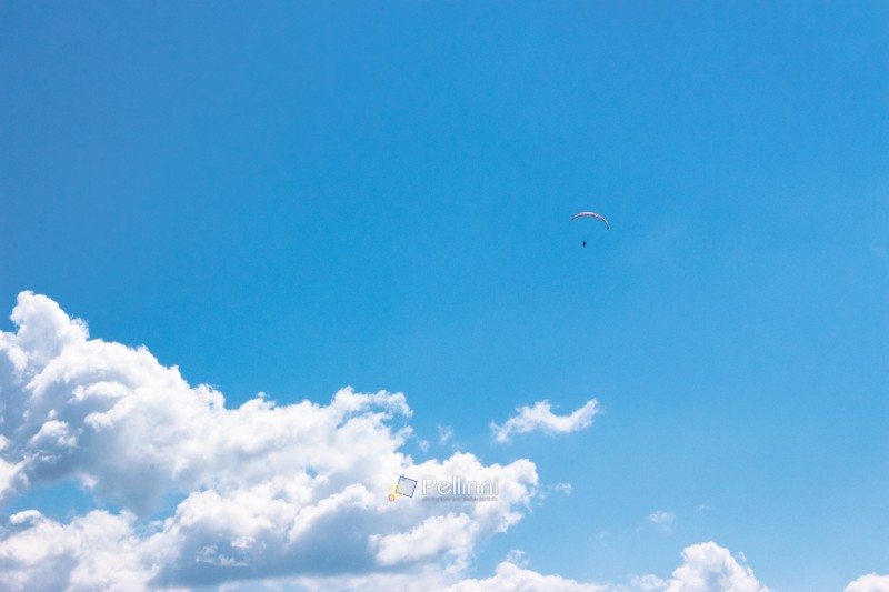 white fluffy clouds on the azure blue sky. cumulus cloudscape in bright light in summer. weather background for vacation on a sunny day. cloudy atmosphere brings fresh air concept