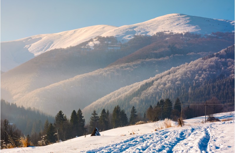wonderful winter landscape in mountains. beautiful countryside with snow covered mountains in the distance. location Pylypets, TransCarpathian region, Ukraine