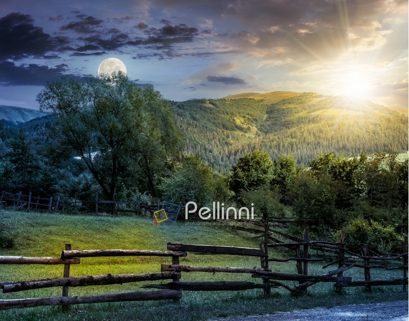 day and night composite image of wooden fence on agricultural grassy meadow with trees on hillside in high mountains at sunset