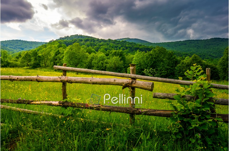 wooden fence on hillside in the rural area. classic countryside landscape of Carpathians
