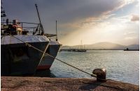 Boats docked to a mooring bollard in the  port of Bulgarian town Sozopol at sunset