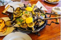 Bulgarian national dish. hot plate with fish, courgettes and onions in a lemon sauce