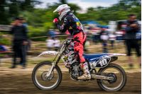 Uzhgorod, Ukraine - May 21, 2017: MX rider Finish the race. Motion blur with flying dirt. TransCarpathian regional Motocross Championship