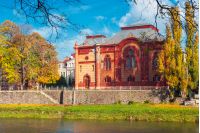 Uzhgorod, Ukraine - NOV 10, 2012: Philharmonic Orchestra Concert Hall on the bank of the river Uzh in autumn. former building of synagogue is a popular tourist attraction. beautiful sunny weather