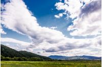 agricultural fields in mountainous countryside. lovely landscape with gorgeous cloudy sky