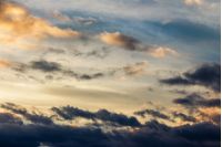 beautiful cloudy sky at sunset. abstract cloud formations colored in to gold by sunlight from below. lovely nature background