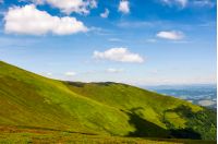 beautiful summer landscape in mountains. fine weather with blue sky and some clouds. gorgeous travel background with footpath through the mountain ridge