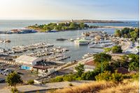 SOZOPOL - AUGUST 9: boats at sunset on August 9, 2015 in Sozopol, Bulgaria. boats and yachts docked near embankment in port of Bulgarian town Sozopol in evening light