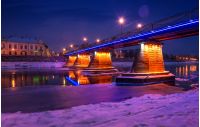bridge through the river Uzh at night. beautiful cityscape of old european town Uzhgorod in winter
