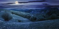 panorama of countryside in mountain at night in full moon light. beautiful landscape in springtime