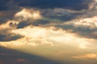 dramatic cloudy sky in warm evening glow. moody meteorology background for stormy weather forecast. spiritual cumulonimbus cloudiness during spring. golden brilliance through sunset sky