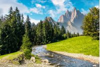 fairy tale mountainous summer landscape. composite image with high rocky peaks above the mountain river in spruce forest