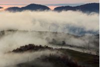 fog above the rural hills at dawn. gorgeous nature autumnal background in mountain