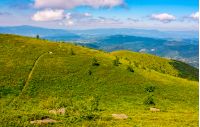 winding footpath through large meadows on the hillside of Carpathian mountain range