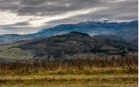 gloomy morning in mountains. autumnal scenery with snowy mountain tops