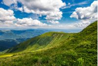 grassy slopes under the beautiful cloudscape. gorgeous summer landscape in mountains