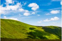 green alps under blue sky. gorgeous mountainous landscape with fresh grassy hills in summer. eternity concept
