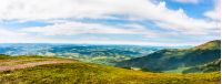 panoramic summer landscape with road through hillside meadow in mountains