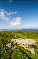 huge boulders on the edge of hillside. fine weather in summer mountain landscape