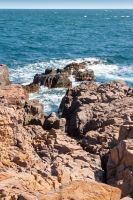 landscape of sea coast with rock in summer. wonderful weekend getaway in europe. textured coastline with blue sky above horizon