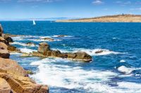 landscape with sea and coast with rock. vacation season with beautiful seascape in summer. travel background with water splash on stone