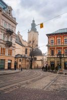 lviv, ukraine - 17 nov 2012: view of lviv city architecture on a misty morning. concept scene of old town with cobblestone street. background for travel urban europe in autumn
