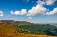 grassy hillside of mountain ridge. good weather with blue sky and few clouds. lovely summer landscape