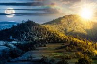 mountainous rural landscape on summer solstice. day and night time change concept. field and forest on the hill with sun and moon on sky. alpine countryside in remote mountain region 