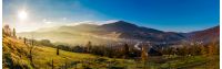 panorama of Volovets town in Carpathian mountains. gorgeous foggy sunrise with Magnificent Borzhava mountain ridge in a distance. beautiful countryside landscape in autumn