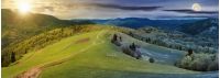 panorama of night and day time change above countryside. path down the grassy rural hills rolling in to the distance. ridge beneath an overcast sky with sun and moon in spring