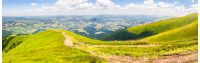panoramic mountain landscape. curve path through the meadow on hillside