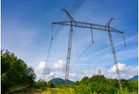 power line tower on a hillside. giant metal construction in beautiful landscape. power and energy concept