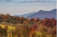ridge with peaks above hillside with forest. lovely mountainous background in late autumn
